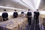 Employees next to cargo in Air Canada plane