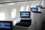 Passenger seats with TVs in the Air Canada Signature Class cabin